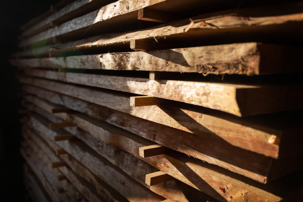 Stacked timber boards in a woodworking workshop
